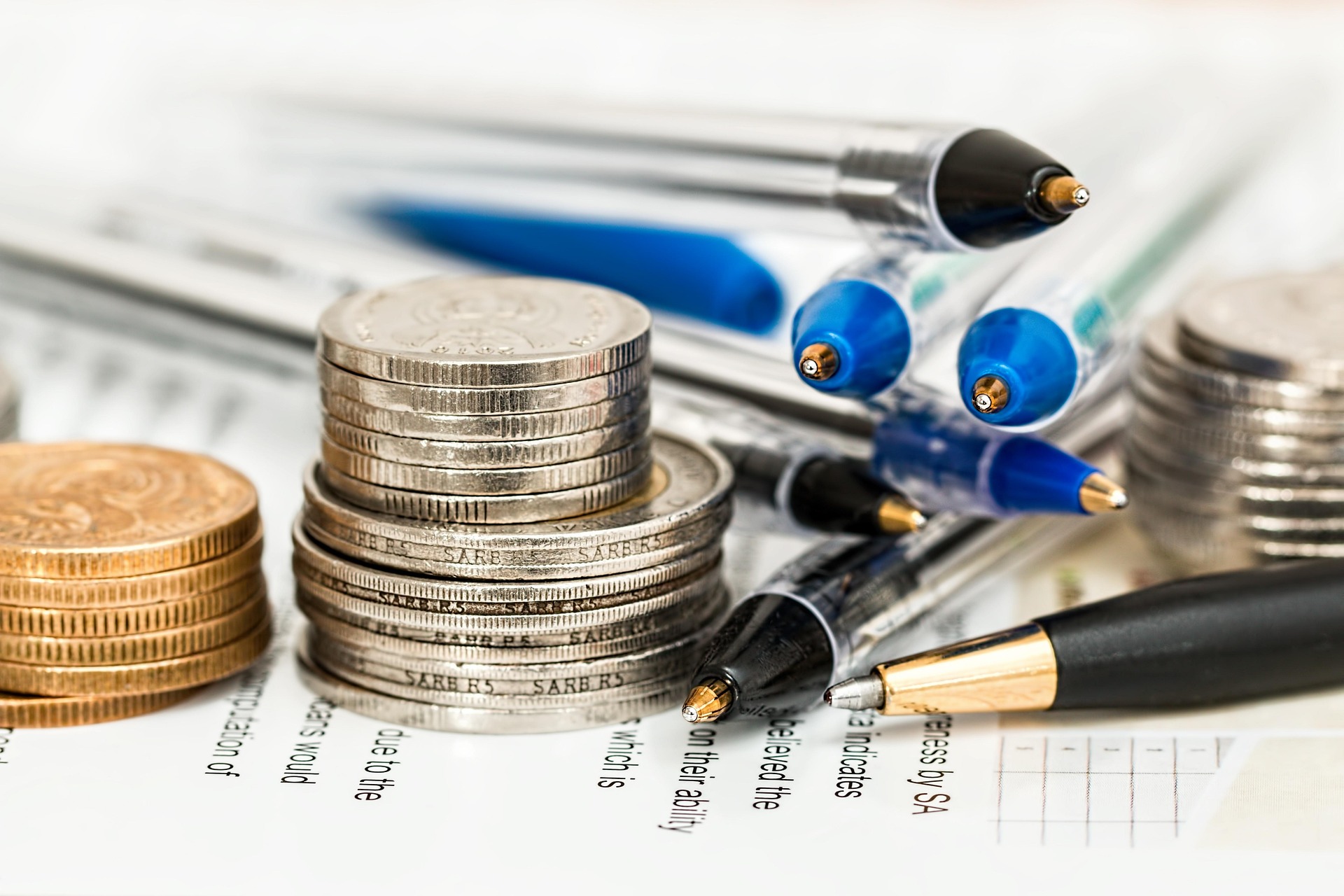 Coins and pens on financial documents