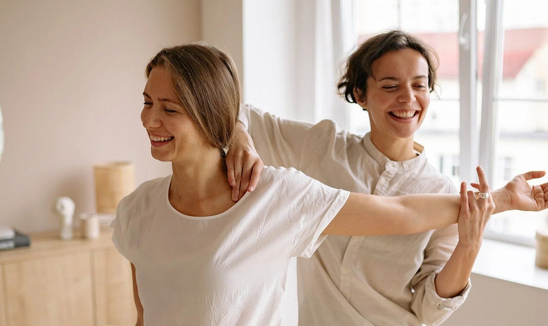 Therapist assisting patient with movement.