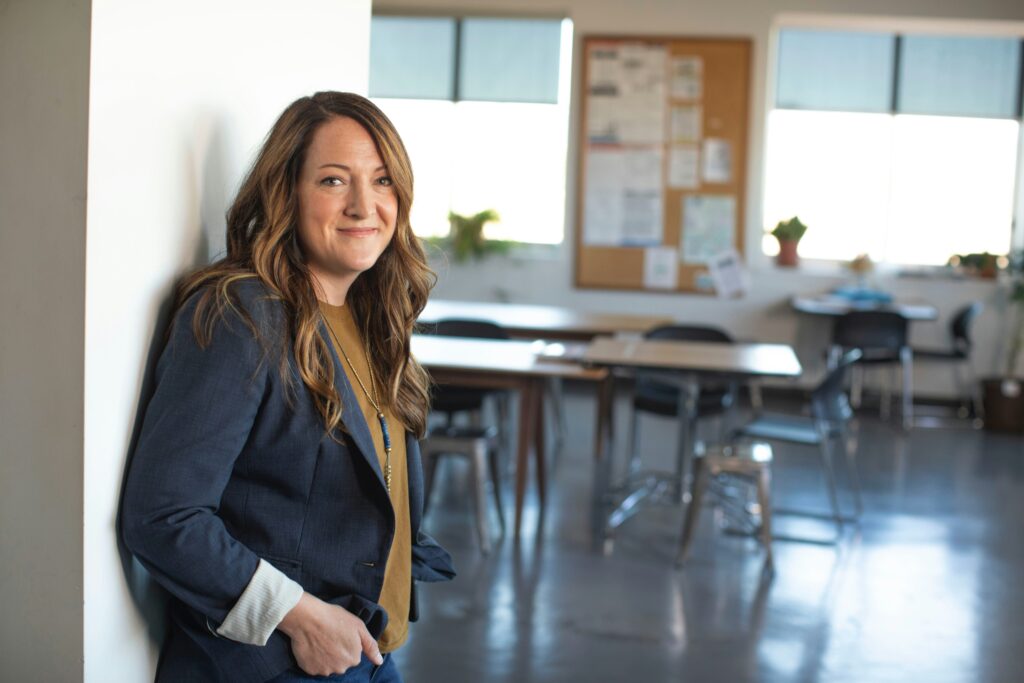 Professional counselor standing in a therapy or classroom setting, representing malpractice insurance for counselors and liability protection in mental health practice