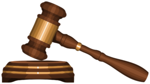 A wooden judge’s gavel and sound block representing legal law and attorney malpractice insurance regulations, isolated on a black background.
